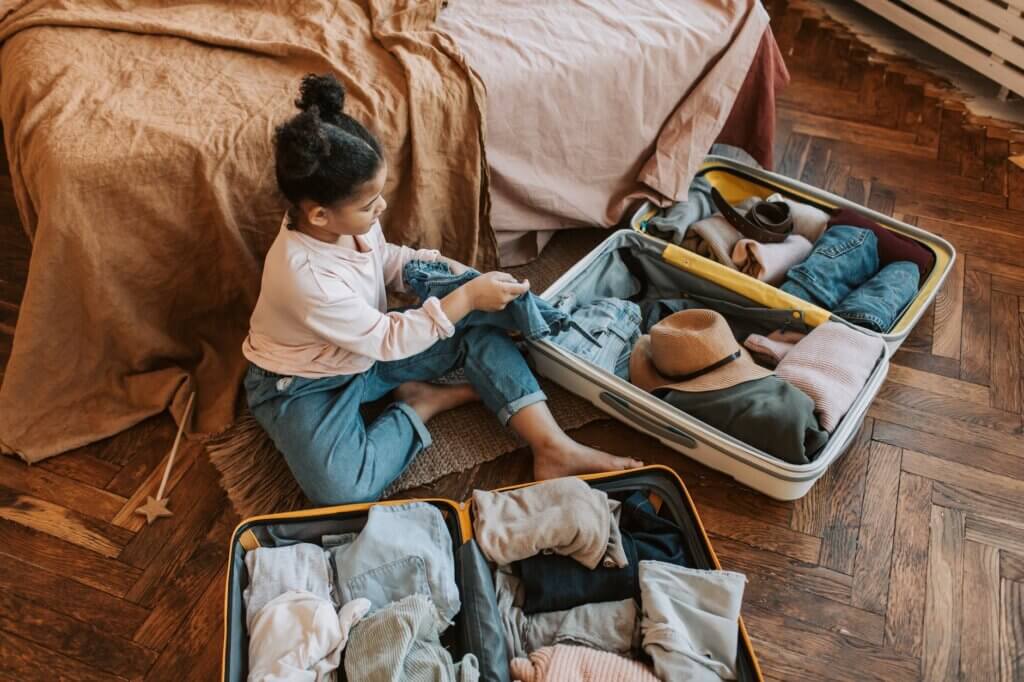 little girl packing a suitcase